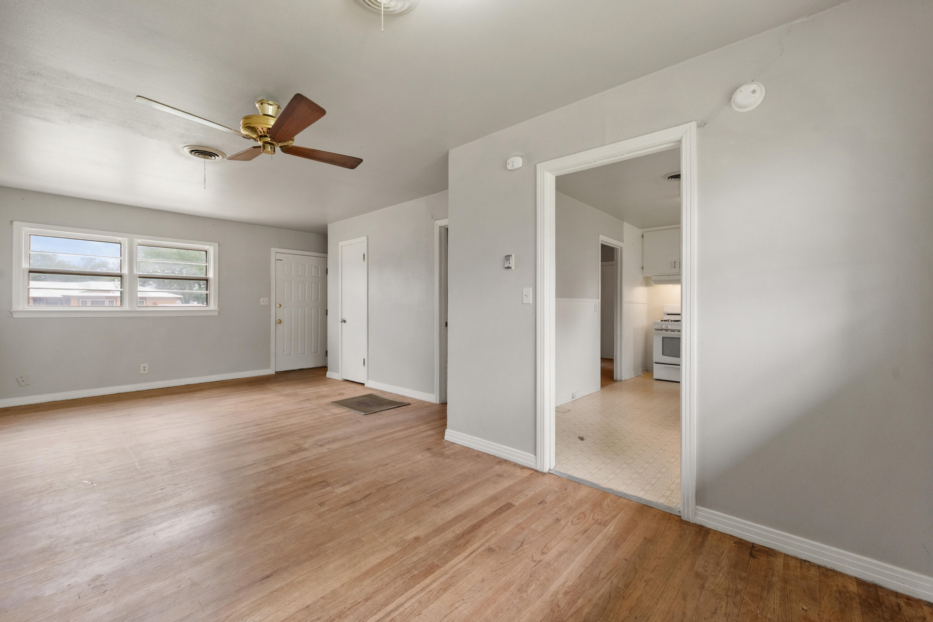 811 Zephyr Plainview, TX 79072 - Photo 9 of 25 a view of empty room with wooden floor and fan