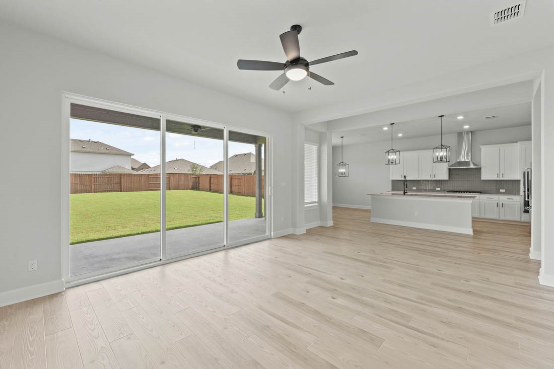 17109 Howdy Way Manor, TX 78653 - Photo 9 of 24 The large family room is located at the heart of the home offering the ideal space for gathering with friends and family. Large windows along the back of the home offer views of the covered outdoor living area and your large back yard.