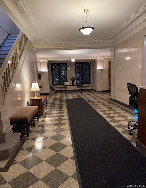 390 Riverside Drive, Unit 12AC Manhattan, NY 10025 - Photo 25 of 29 Building lobby with ornamental molding and stairway