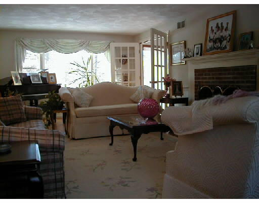 302 Flagg Hill Road Boxborough, MA 01719 - Photo 4 of 4 a living room with furniture a window and a fireplace