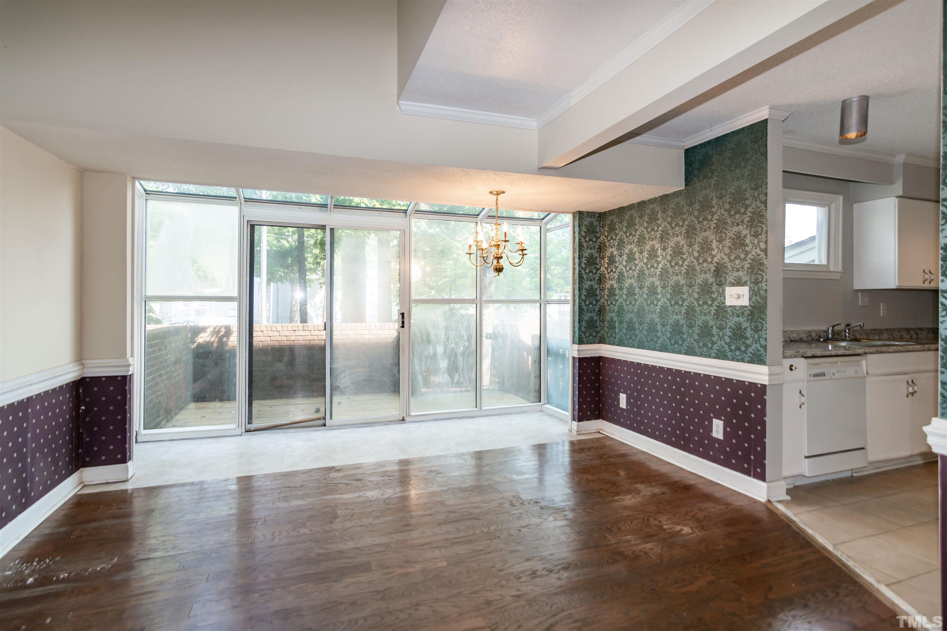 7050 Sandy Forks Road, Unit 103 Raleigh, NC 27615 - Photo 8 of 33 a living room with stainless steel appliances granite countertop a couch and cabinets