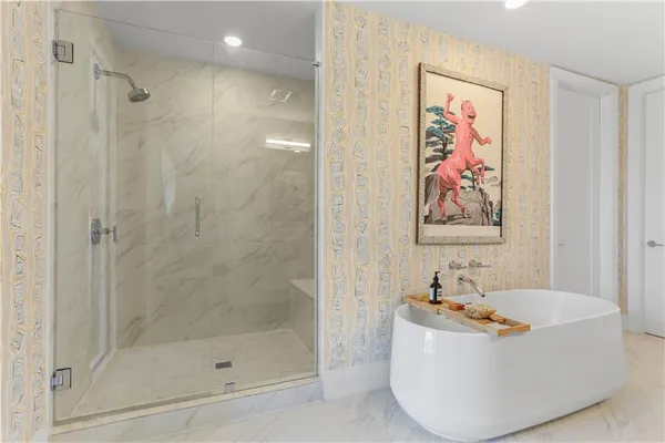 a bathroom with a tub and shower