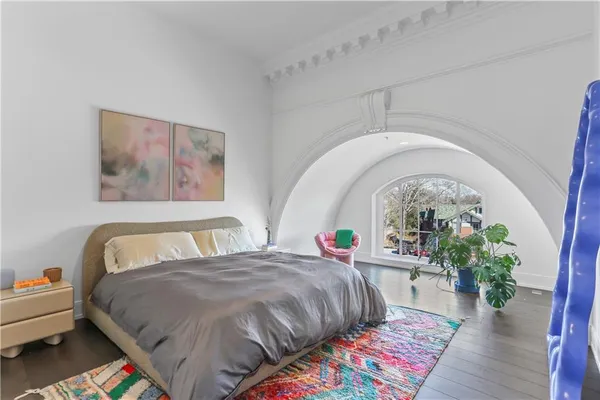 a bedroom with a bed and a potted plant