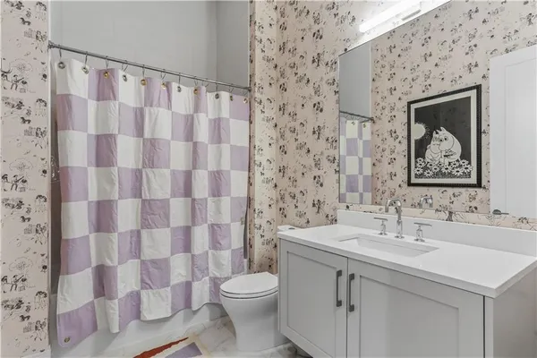 a bathroom with a sink toilet and shower
