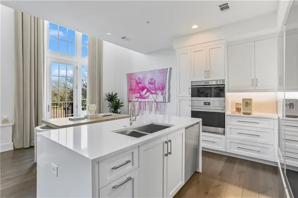 a kitchen that has a sink and a stove in it