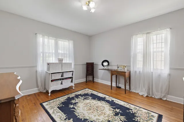 a bedroom with furniture and a rug