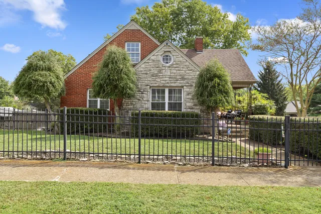 a front view of a house with a small garden
