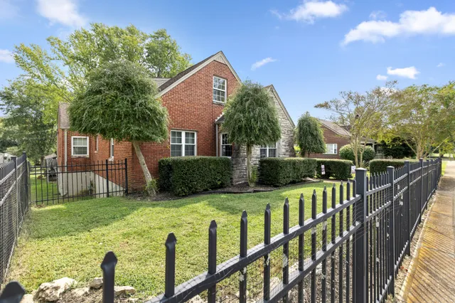 a view of a house with wooden fence