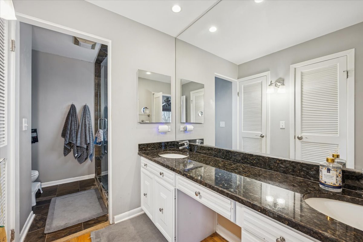 1908 McCraren Road Highland Park, IL 60035 - Photo 23 of 37 a bathroom with a granite countertop sink a mirror and a shower