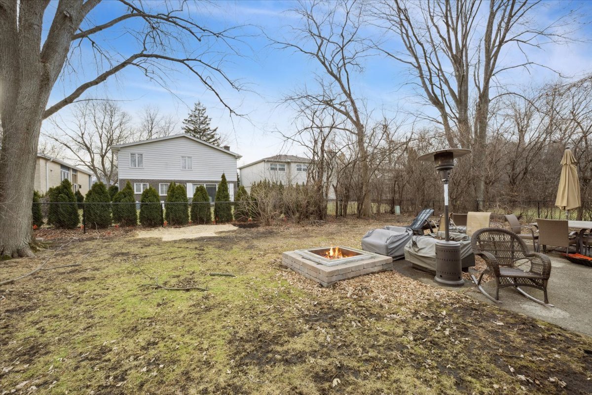 1908 McCraren Road Highland Park, IL 60035 - Photo 28 of 37 a view of a backyard with table and chairs under an umbrella