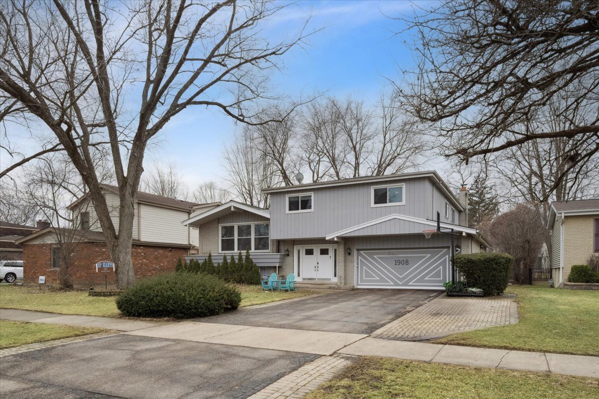 1908 McCraren Road Highland Park, IL 60035 - Photo 3 of 37 a front view of a house with a garden and trees