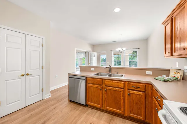 a kitchen with sink cabinets and wooden floor