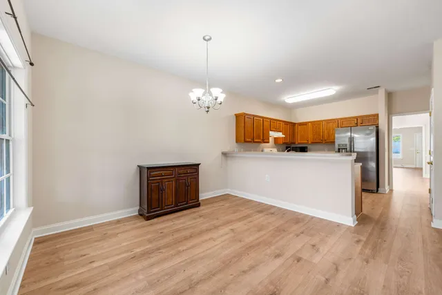 a view of a kitchen with a dishwasher and wooden floor