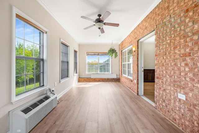a view of an entryway with wooden floor