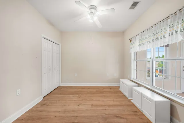 a view of a hallway with wooden floor and a large window