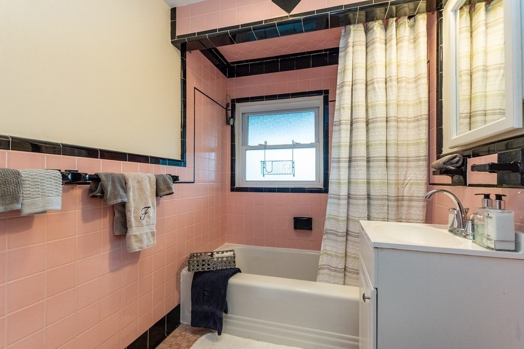 57 Cook Street Newton, MA 02458 - Photo 16 of 28 a bathroom with a bathtub sink and mirror