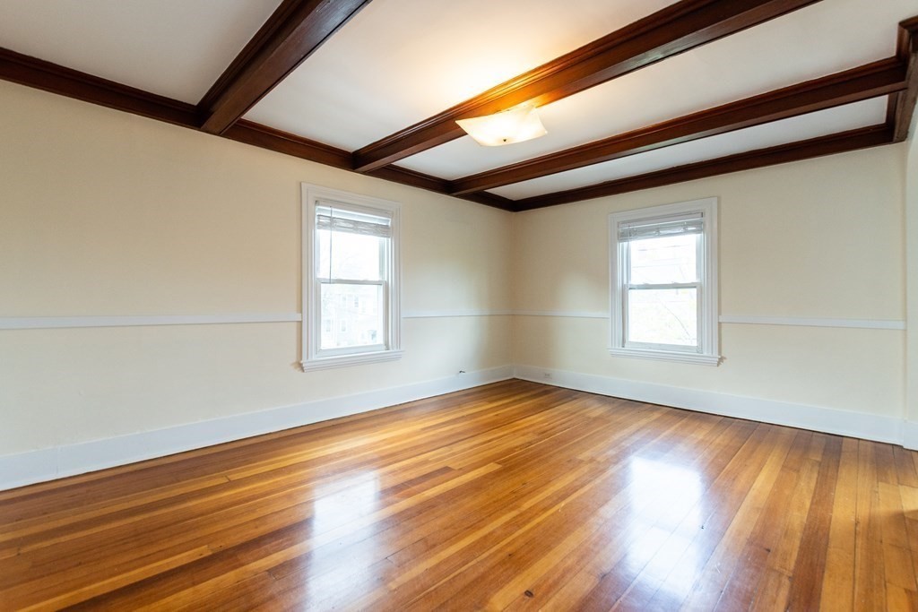 57 Cook Street Newton, MA 02458 - Photo 17 of 28 a view of empty room with wooden floor and fan