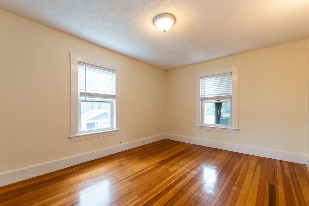 57 Cook Street Newton, MA 02458 - Photo 18 of 28 an empty room with wooden floor and windows