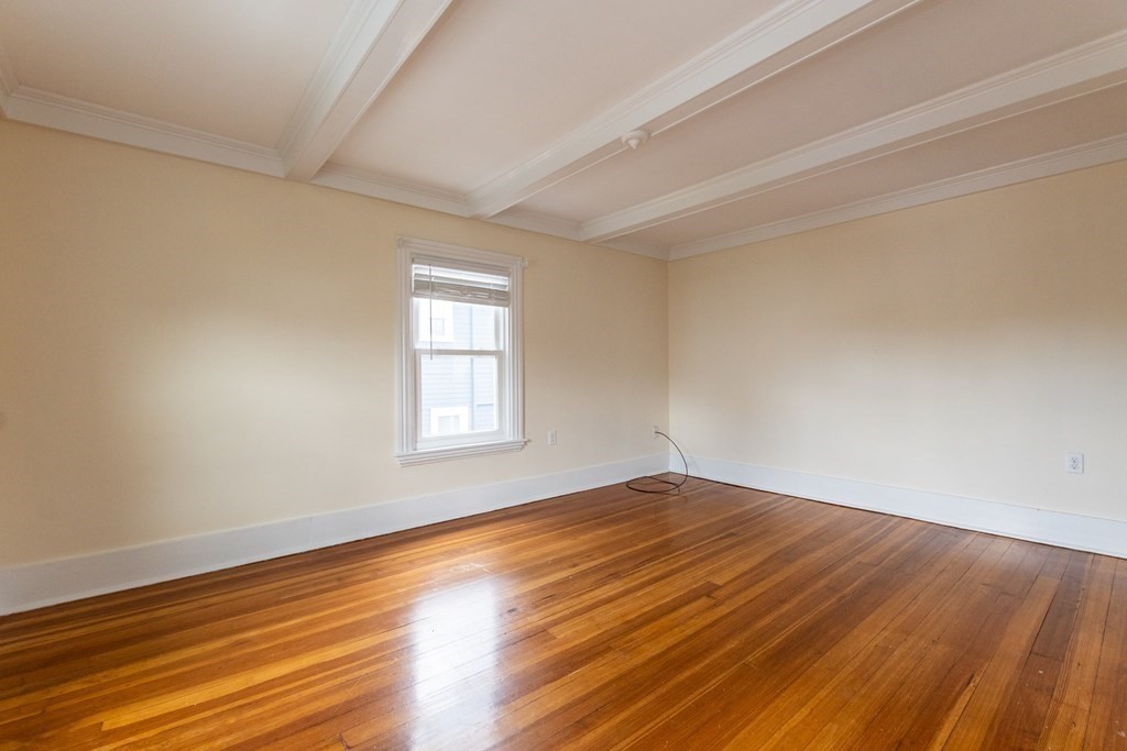 57 Cook Street Newton, MA 02458 - Photo 19 of 28 a view of an empty room with wooden floor and a window