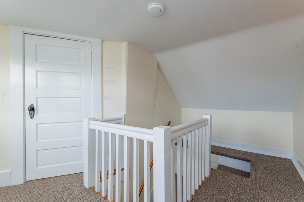 57 Cook Street Newton, MA 02458 - Photo 24 of 28 a view of staircase with white walls and white door