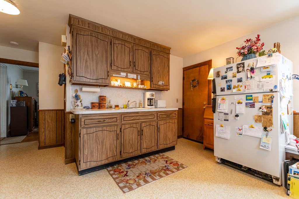 57 Cook Street Newton, MA 02458 - Photo 3 of 28 a kitchen with refrigerator cabinets and a refrigerator