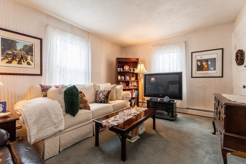 57 Cook Street Newton, MA 02458 - Photo 6 of 28 a living room with furniture a flat screen tv and a window
