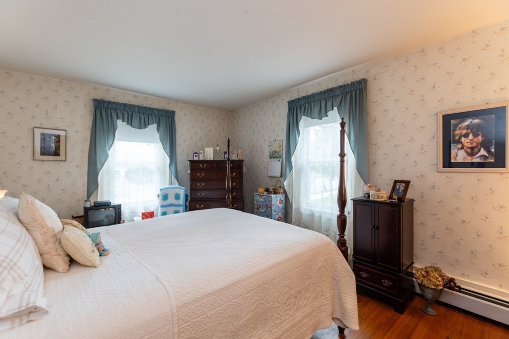 57 Cook Street Newton, MA 02458 - Photo 9 of 28 a bedroom with a bed and wooden floor
