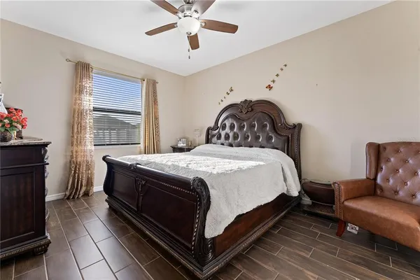 a bedroom with a bed and a chandelier