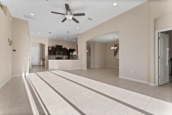 a large white kitchen with a sink and a refrigerator