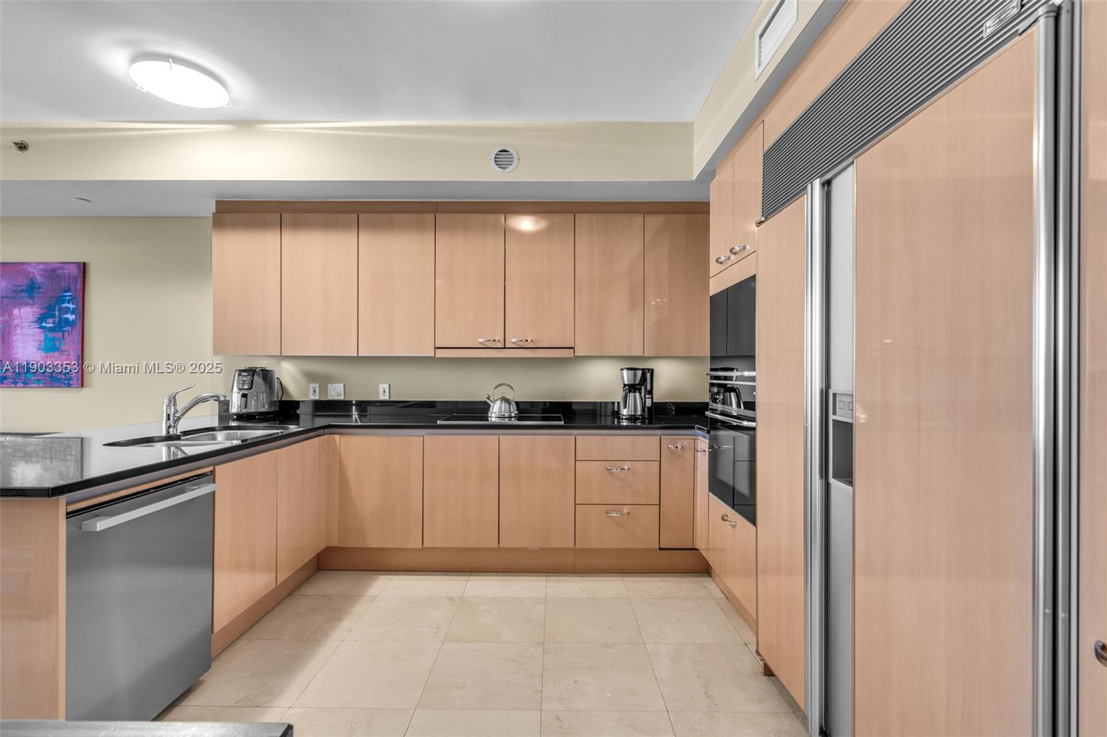 791 Crandon Boulevard, Unit 1402 Key Biscayne, FL 33149 - Photo 11 of 56 a kitchen with stainless steel appliances granite countertop a refrigerator and sink