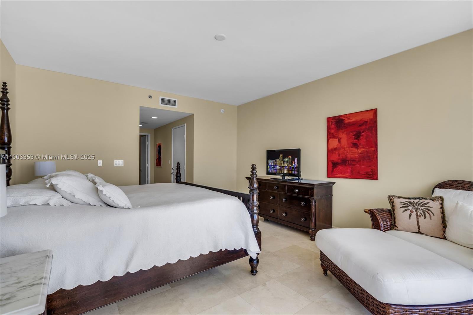 791 Crandon Boulevard, Unit 1402 Key Biscayne, FL 33149 - Photo 20 of 56 a bedroom with a bed and dresser