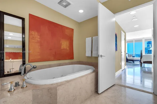 a white toilet sitting next to a bathroom sink