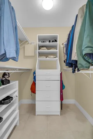 a bathroom with a granite countertop sink mirror vanity and toilet
