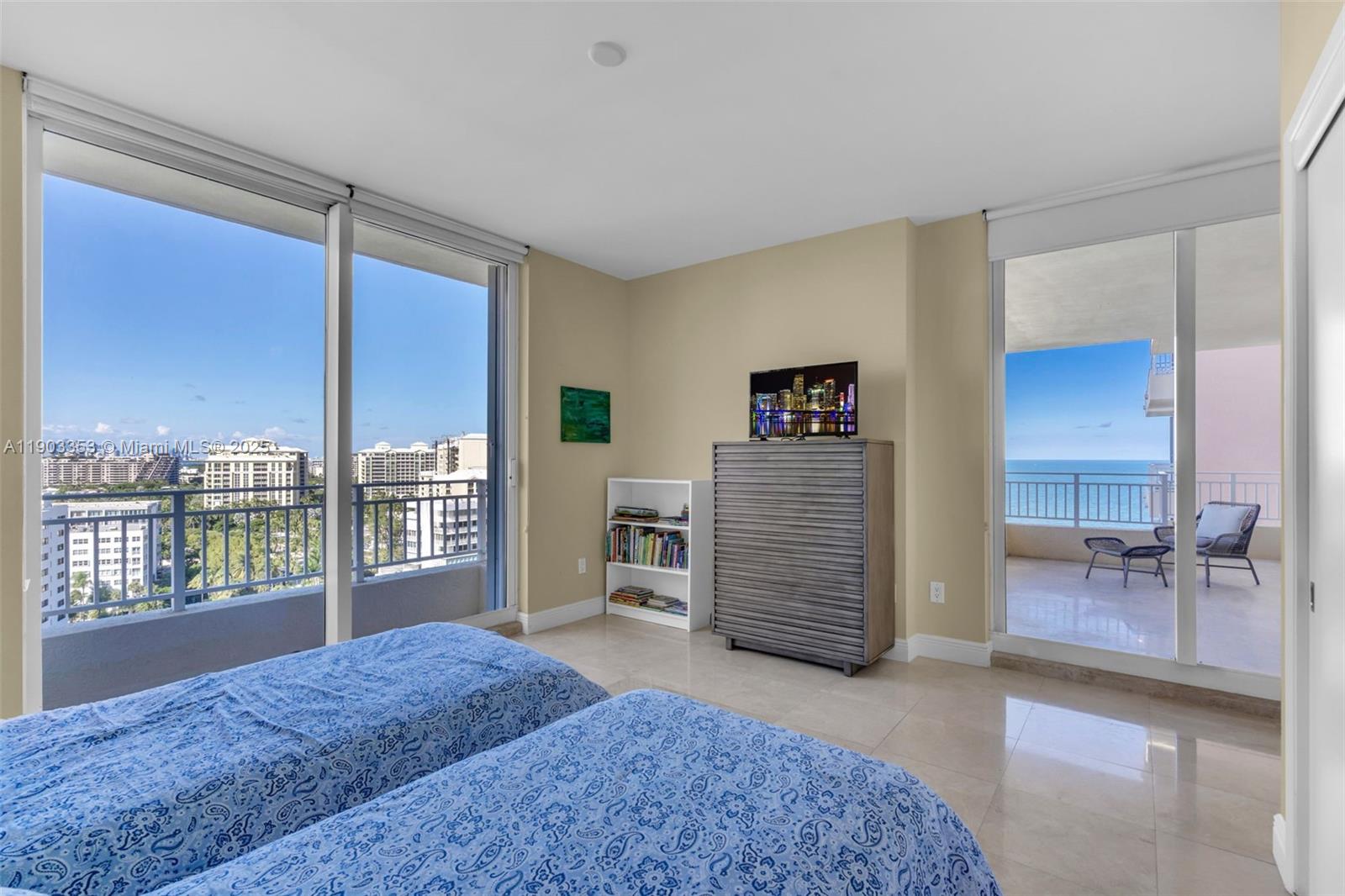 791 Crandon Boulevard, Unit 1402 Key Biscayne, FL 33149 - Photo 32 of 56 a living room with furniture a flat screen tv and large window