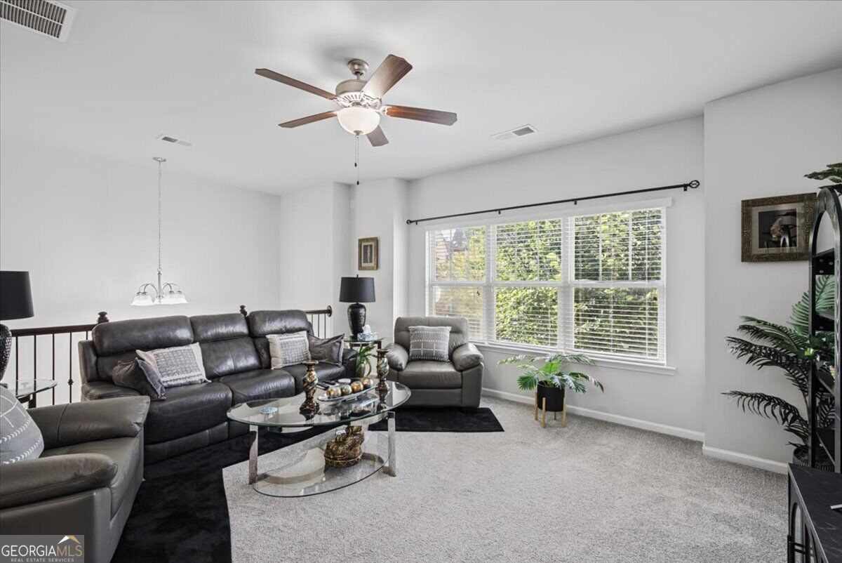 4192 Integrity Way Powder Springs, GA 30127 - Photo 3 of 29 Open-concept living in the sun-filled living area with fresh new carpet