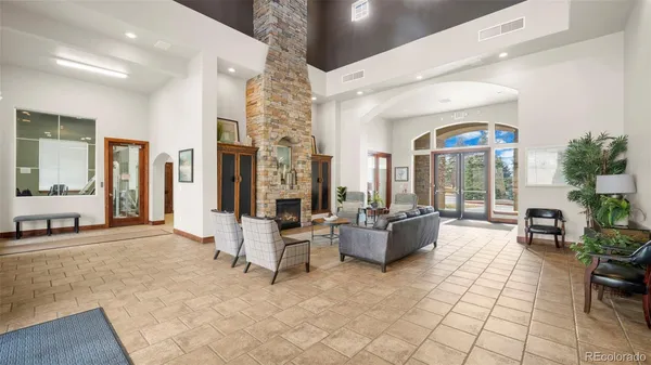 a living room with patio furniture and a large window