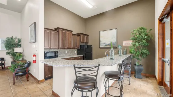 a view of kitchen with furniture and refrigerator