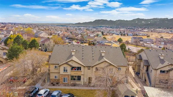 an aerial view of residential houses with outdoor space and ocean view