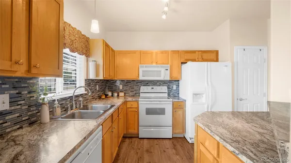 a kitchen with a sink a stove and refrigerator