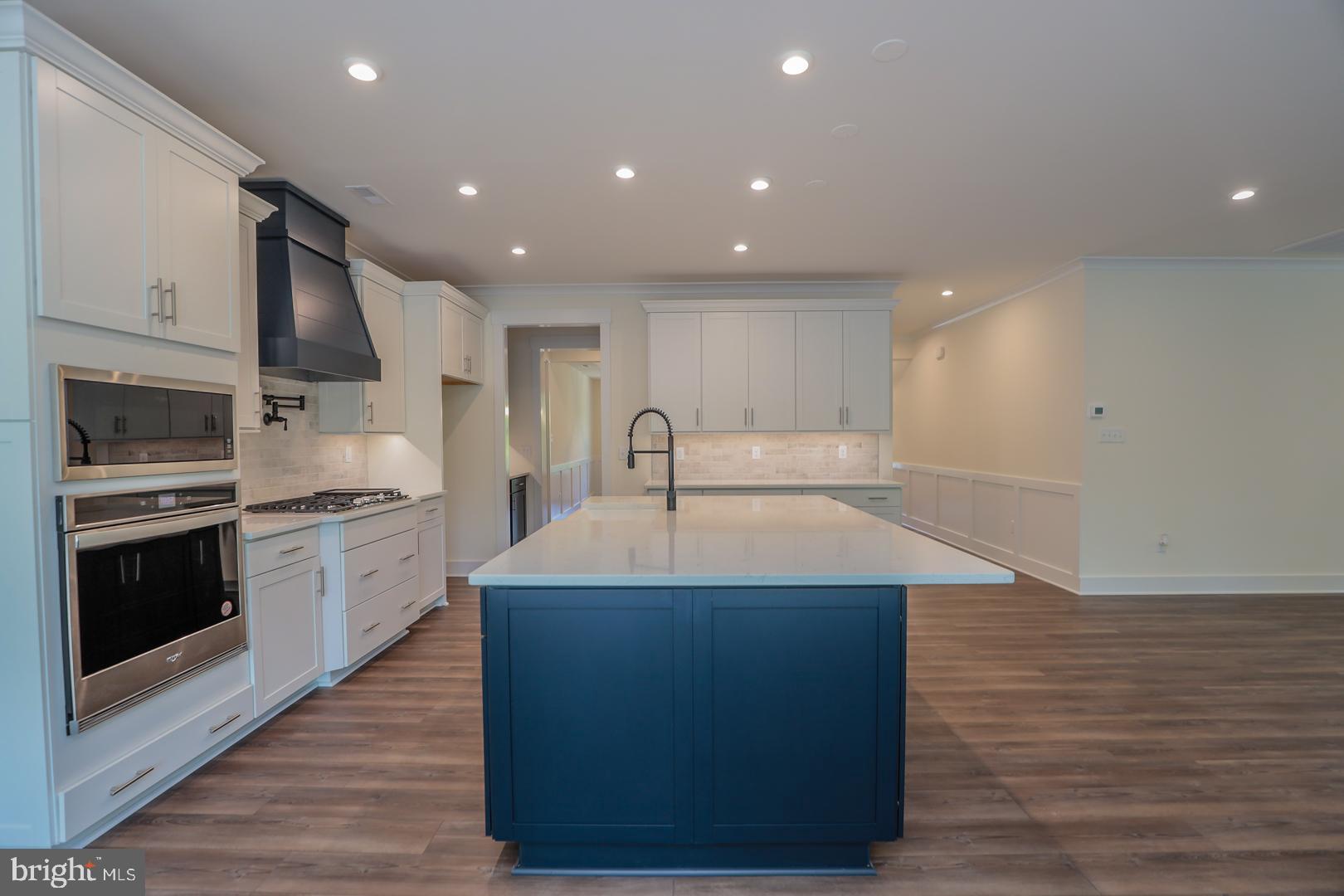 16877 Watchman Way Beaverdam, VA 23015 - Photo 2 of 10 a kitchen with kitchen island a sink stainless steel appliances and cabinets