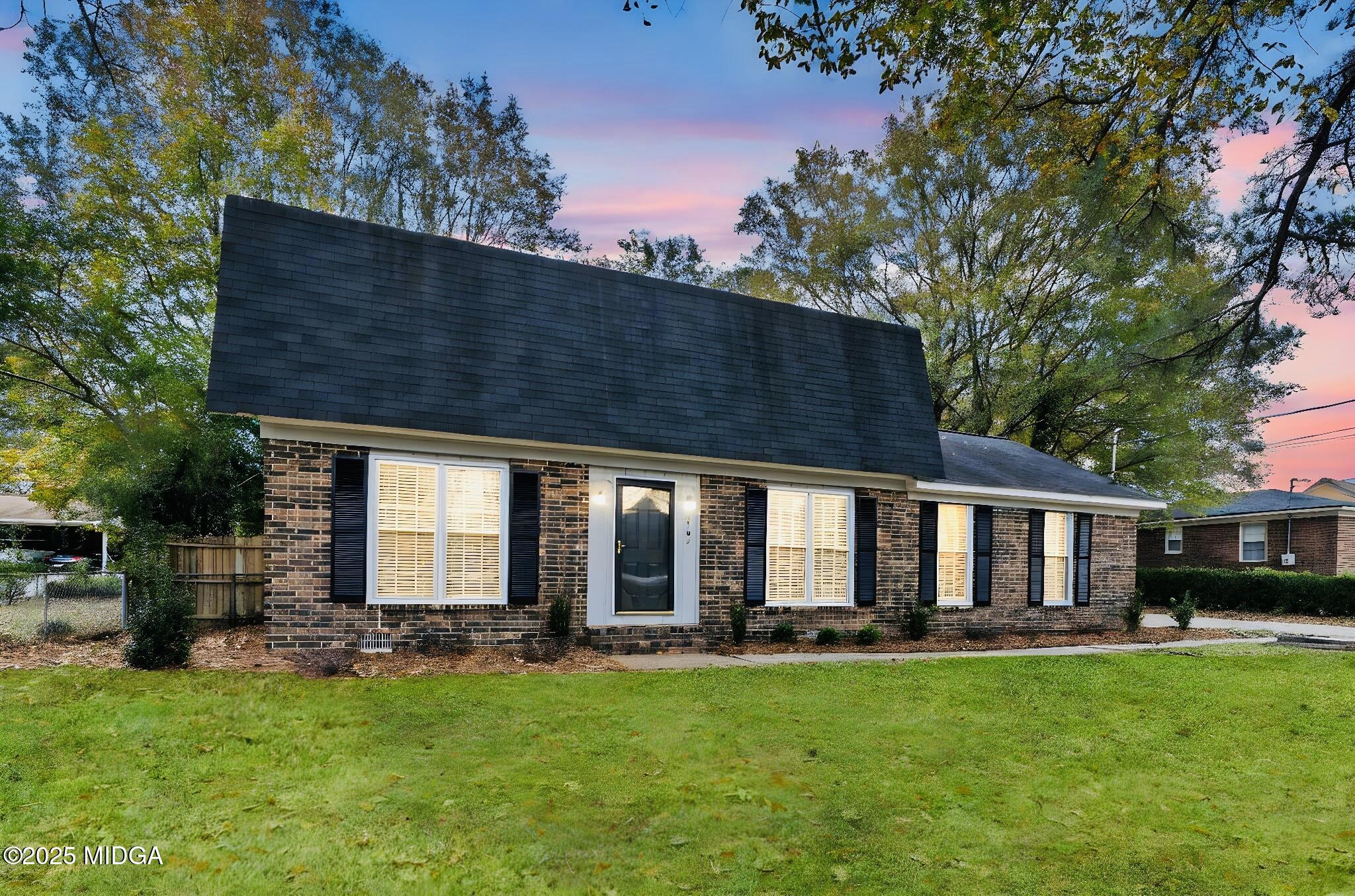 1303 Forest Hill Road Macon, GA 31210 - Photo 1 of 54 a view of a house with backyard and porch