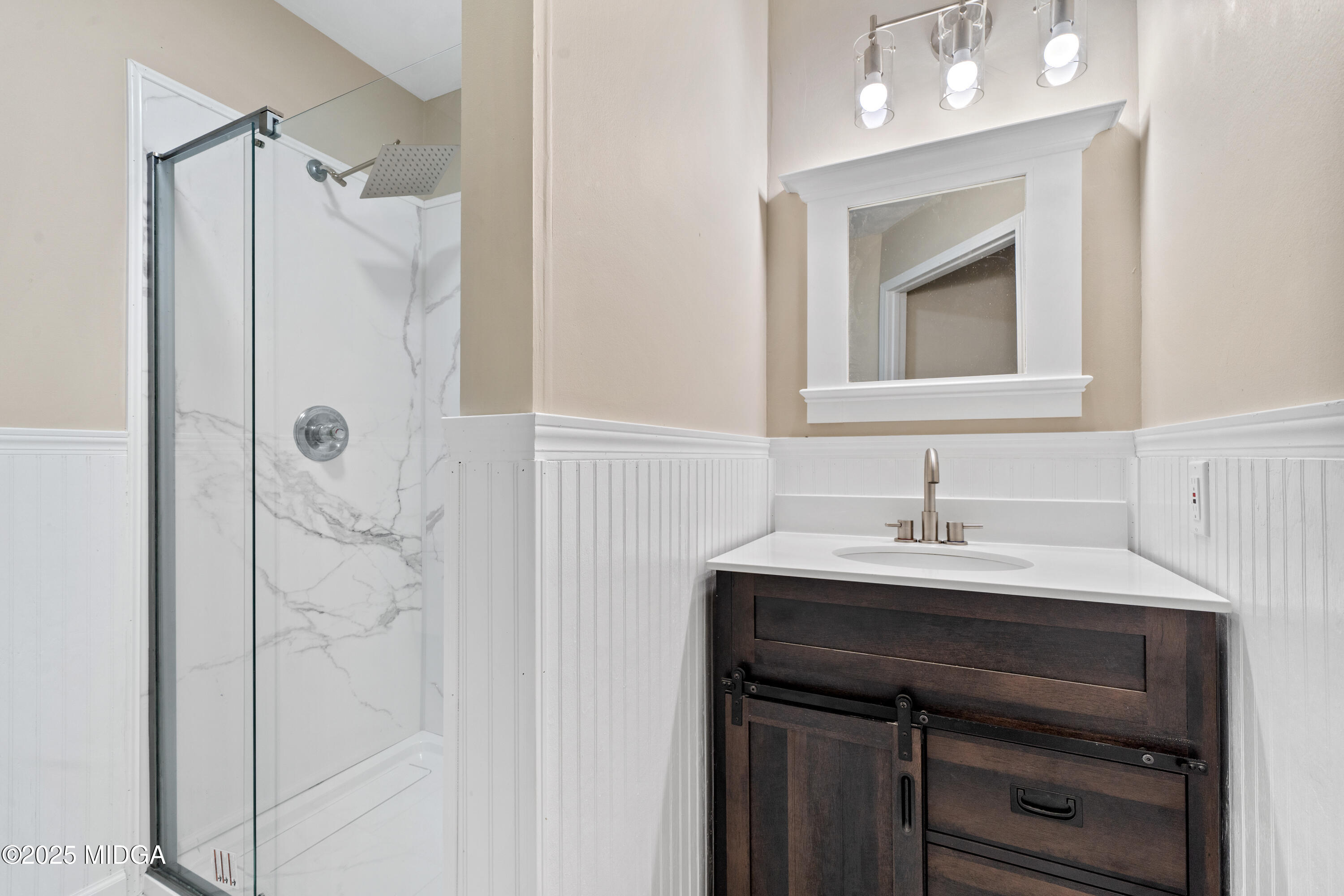 1303 Forest Hill Road Macon, GA 31210 - Photo 12 of 54 a bathroom with a sink a vanity a shower and a mirror