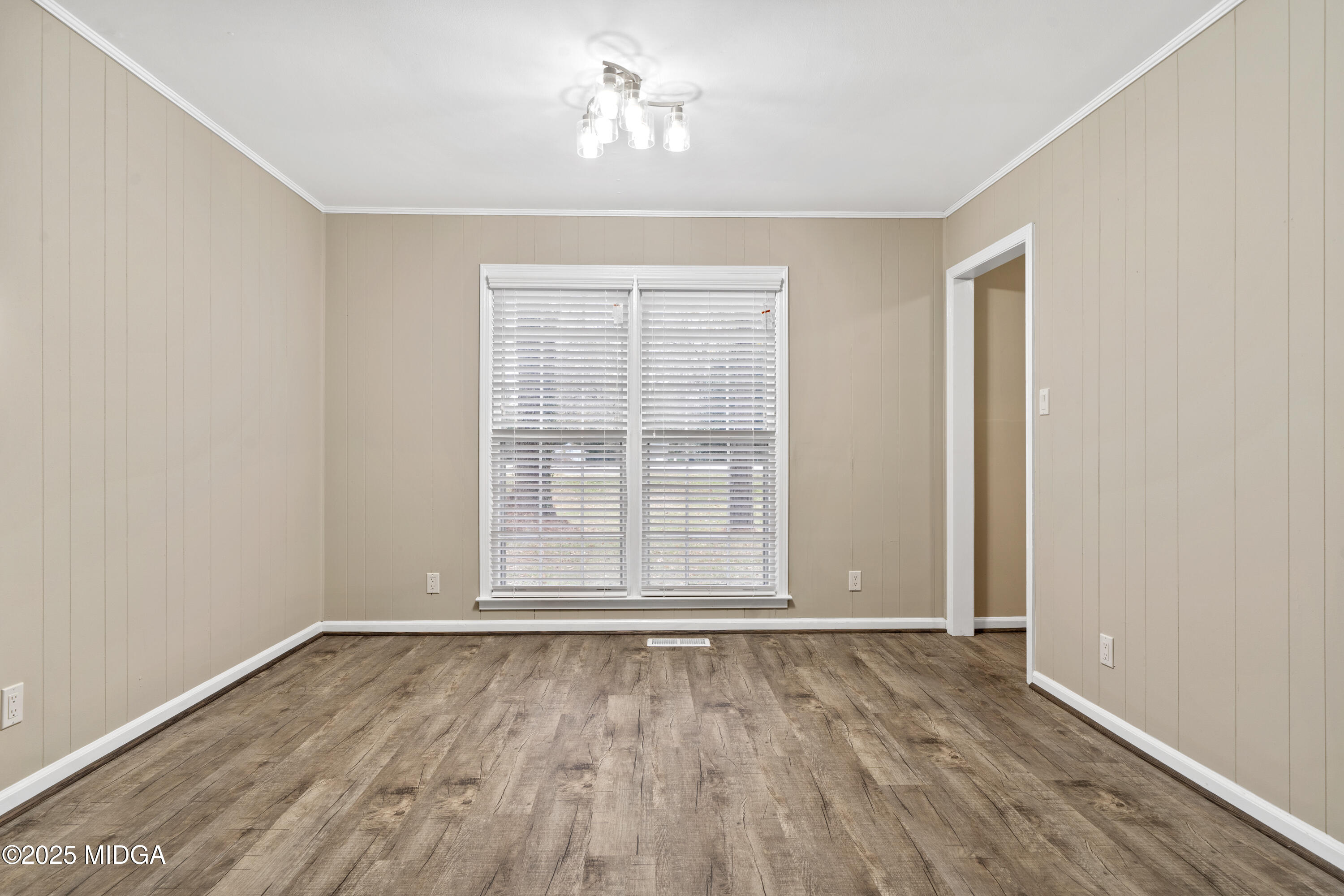 1303 Forest Hill Road Macon, GA 31210 - Photo 14 of 54 an empty room with wooden floor and windows