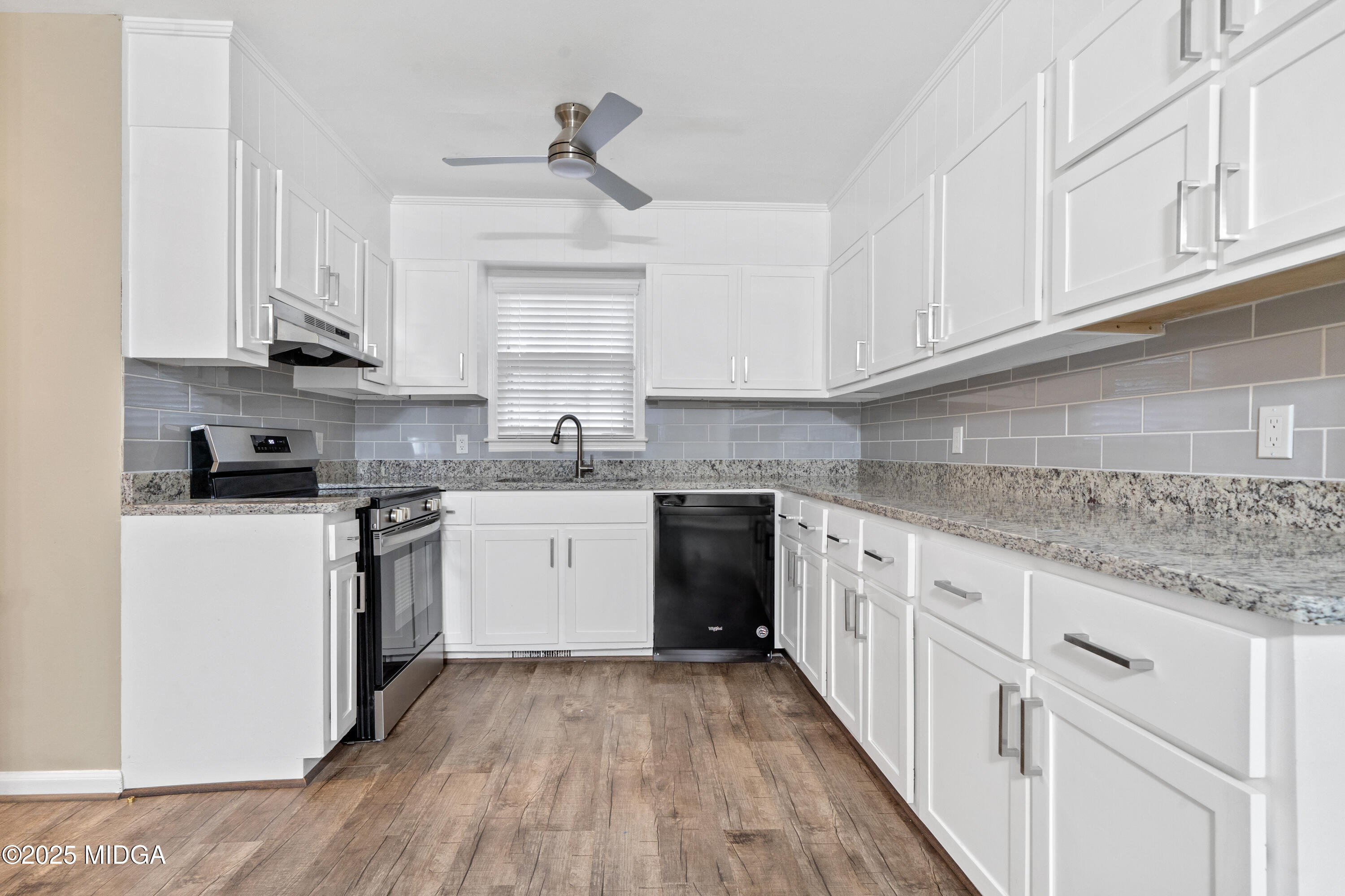 1303 Forest Hill Road Macon, GA 31210 - Photo 18 of 54 a kitchen with granite countertop white cabinets and white appliances