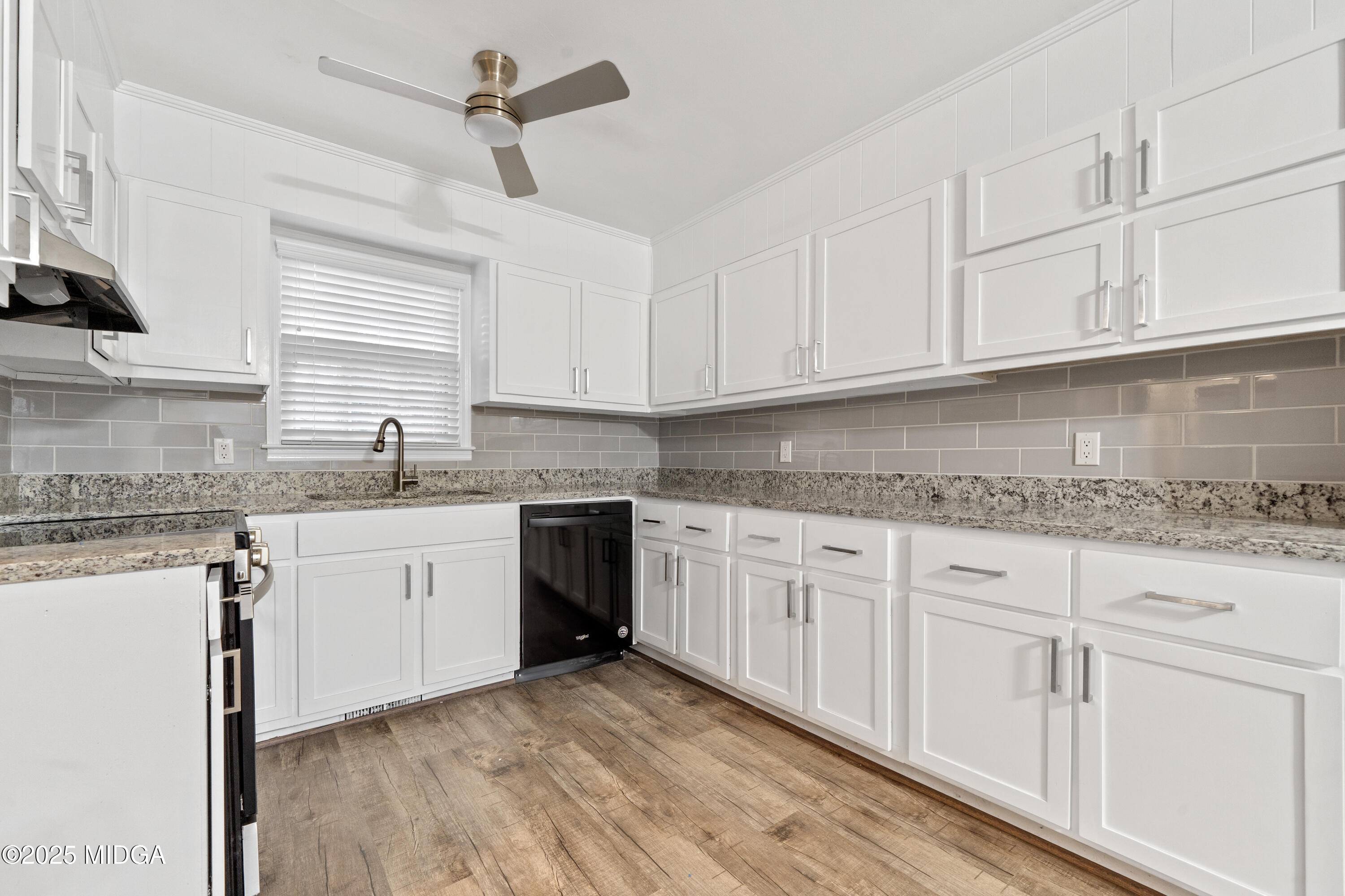 1303 Forest Hill Road Macon, GA 31210 - Photo 19 of 54 a kitchen with granite countertop white cabinets white appliances and granite counter tops