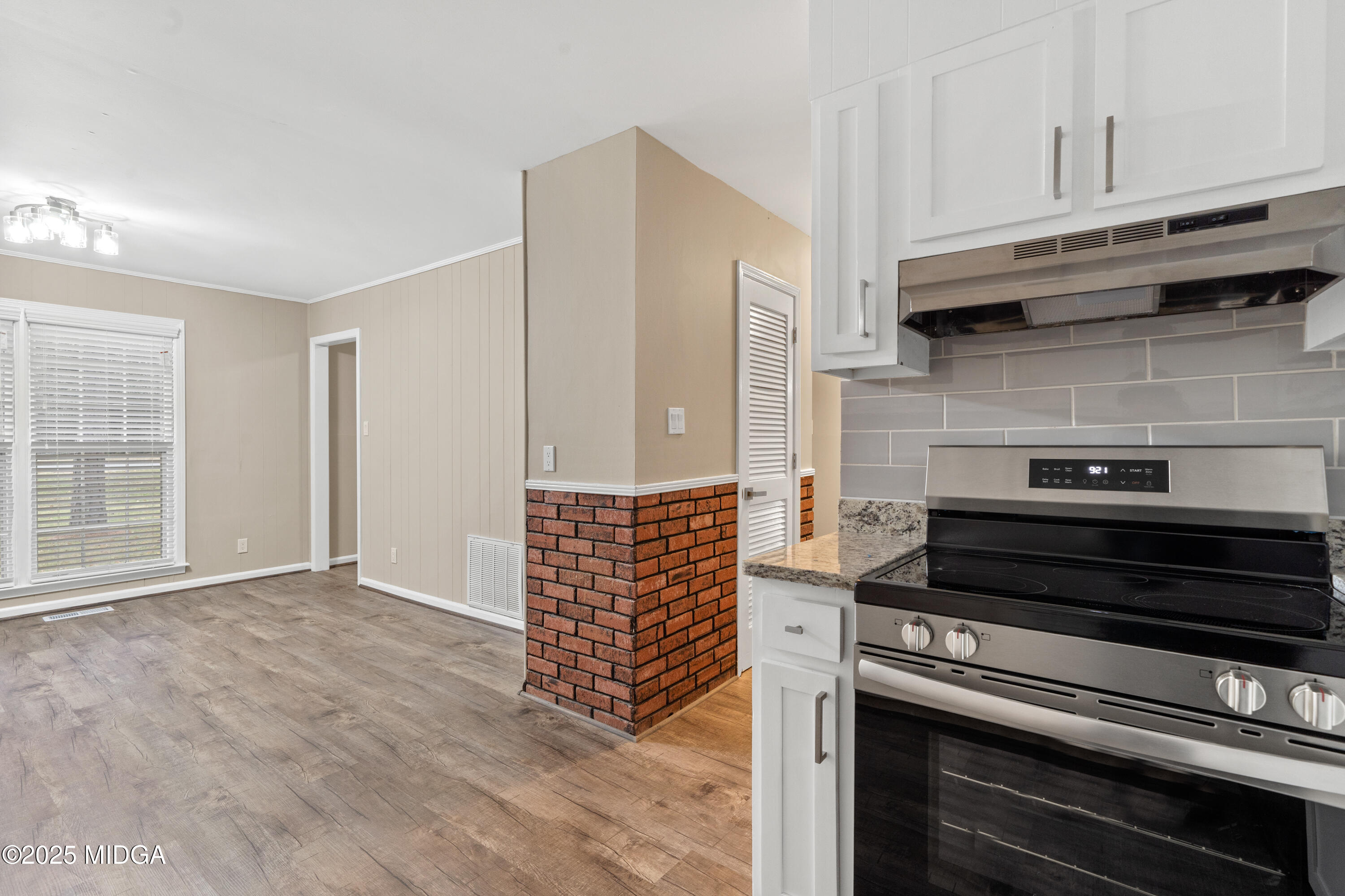 1303 Forest Hill Road Macon, GA 31210 - Photo 21 of 54 a kitchen with wooden cabinets and a stove top oven