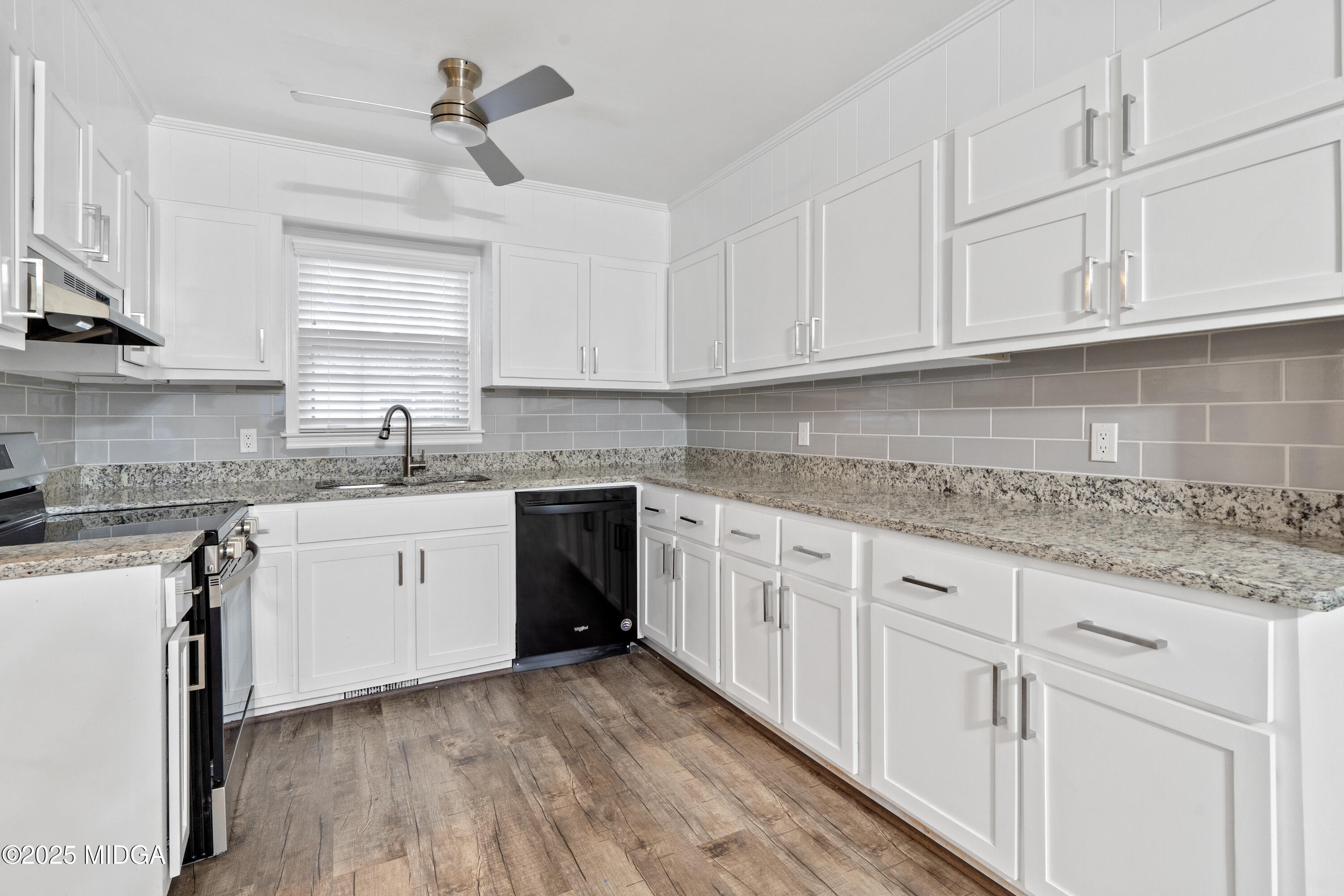 1303 Forest Hill Road Macon, GA 31210 - Photo 23 of 54 a kitchen with granite countertop white cabinets white appliances and sink