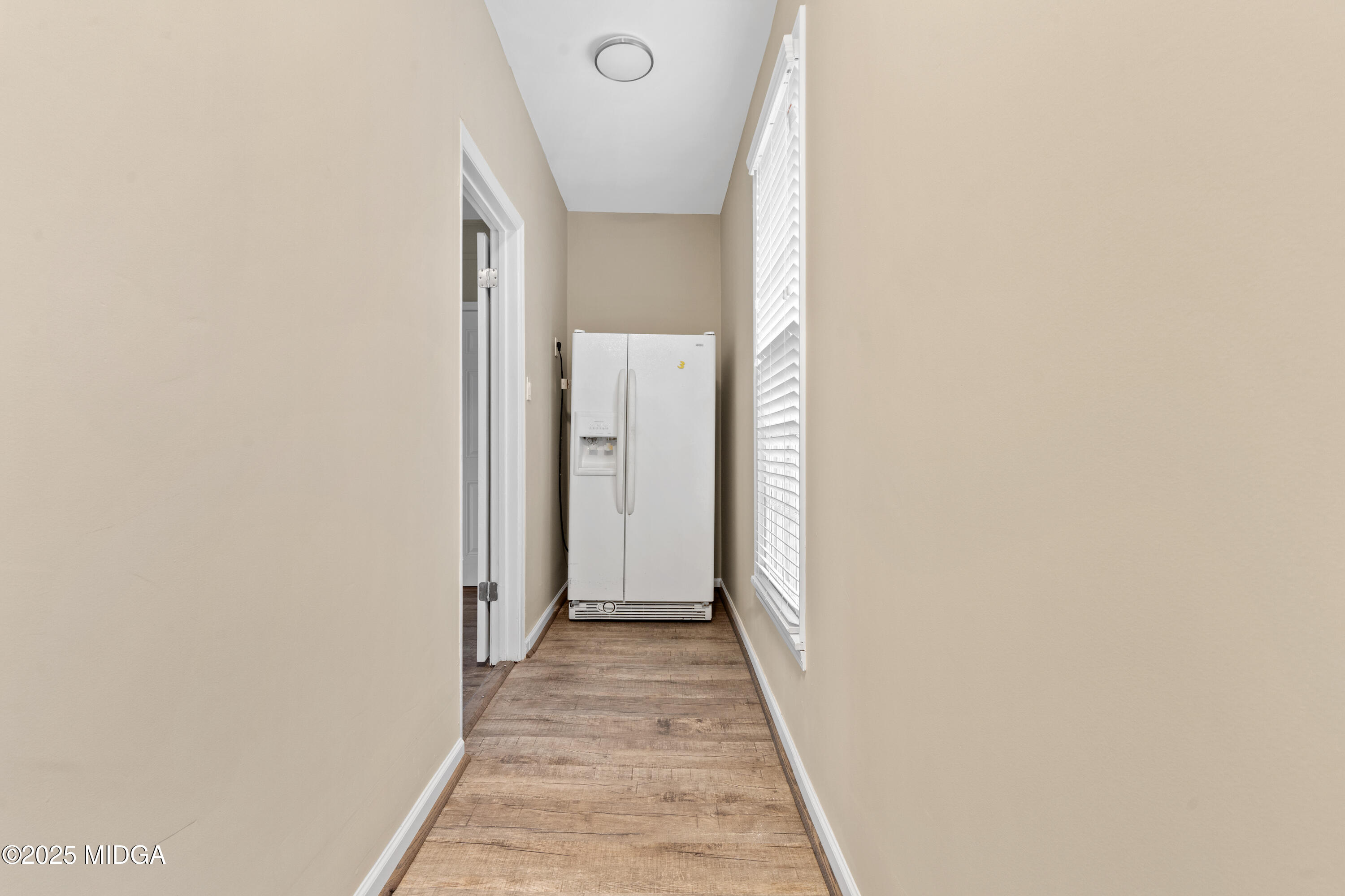1303 Forest Hill Road Macon, GA 31210 - Photo 27 of 54 a view of a hallway with wooden floor and a bathroom