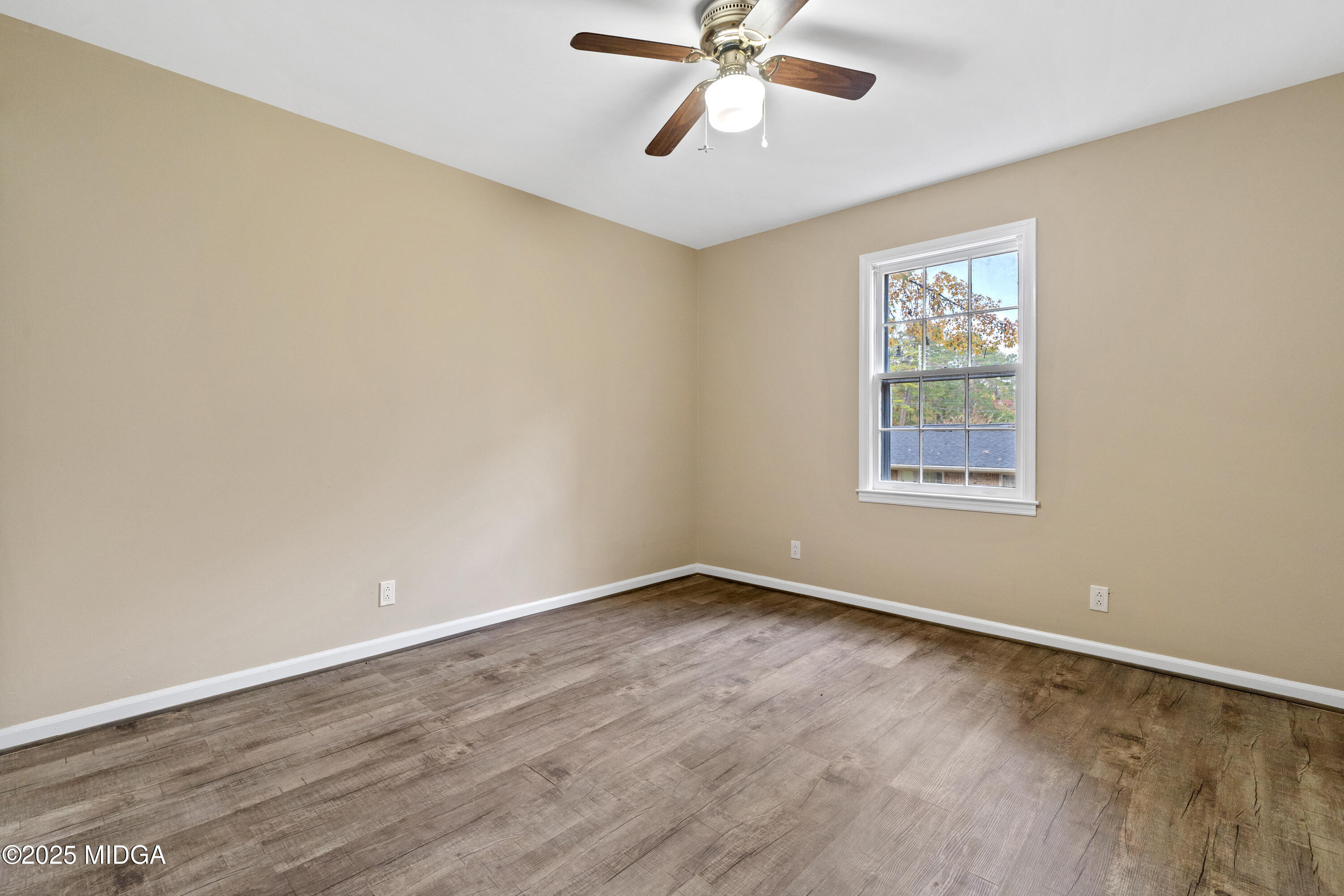 1303 Forest Hill Road Macon, GA 31210 - Photo 29 of 54 a view of an empty room with a window and wooden floor