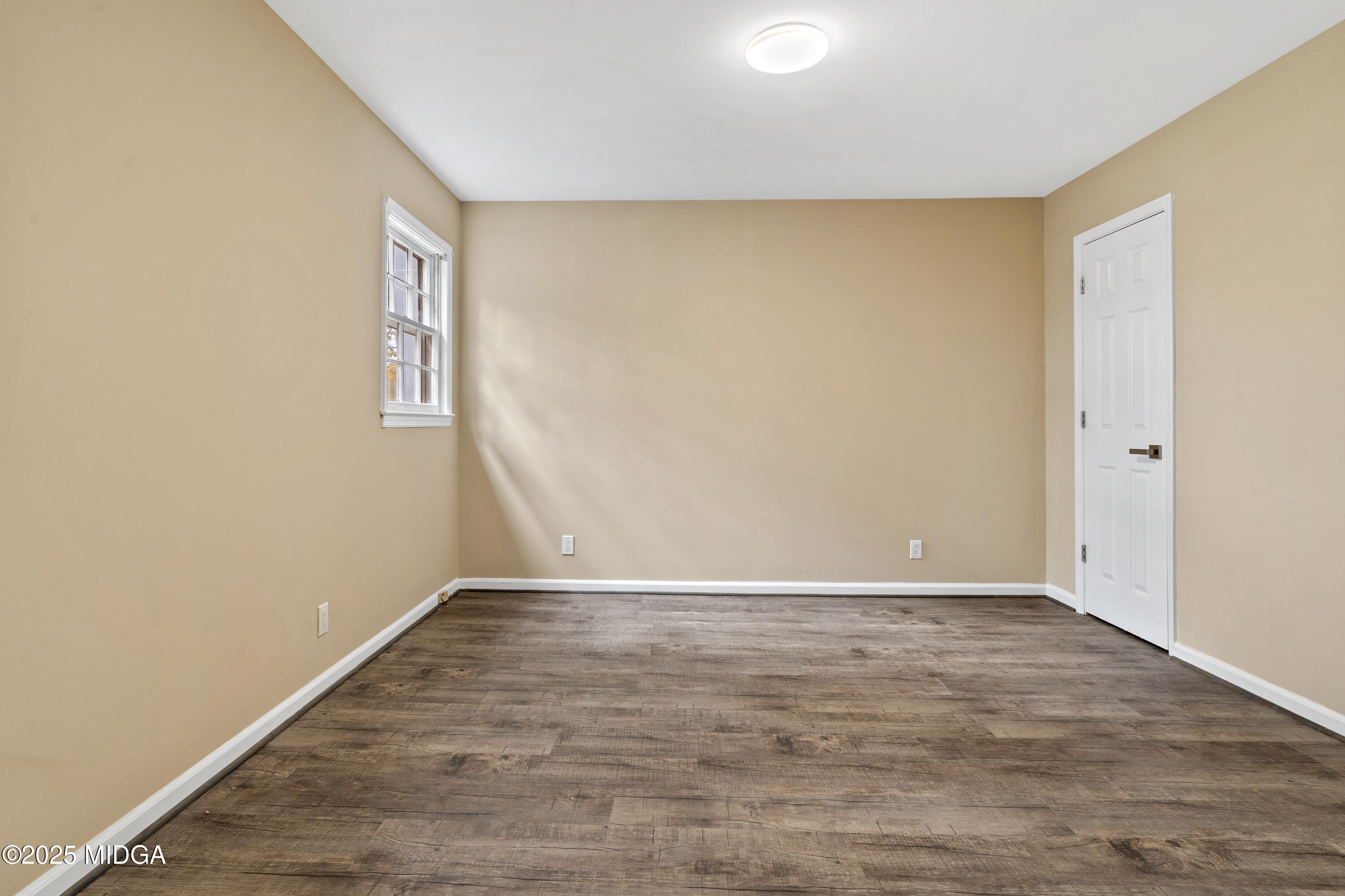 1303 Forest Hill Road Macon, GA 31210 - Photo 31 of 54 a view of an empty room with wooden floor and a window